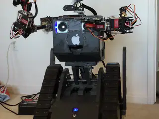 R.O.B. extends both multi-jointed arms outward and adjusts their position during a movement test.