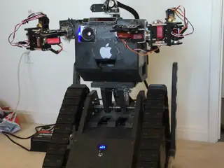 R.O.B. bends both arms inward through a coordinated sequence while facing the camera.