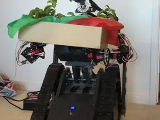 R.O.B. holds the planter steady before a person passes close in front of the camera.