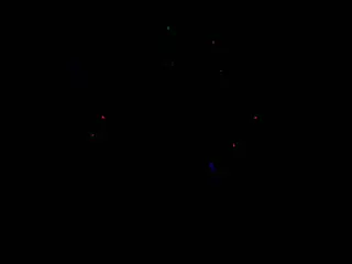 Dark frame containing scattered red, green, and blue points of light.