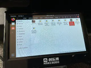 Close-up of the MakerBro monitor displaying an Ubuntu file manager with several media files.