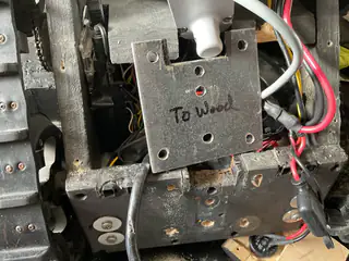 Metal mounting plate labeled To Wood positioned over the robot's chassis wiring.