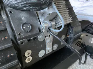 Side view of the rear drive assembly with motor, bracket, cable, and tank tread.