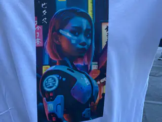 White shirt featuring vivid blue-and-red cyberpunk android artwork framed by Japanese text.