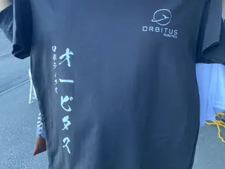 Black Orbitus Robotics shirt with a small logo and vertical Japanese lettering.