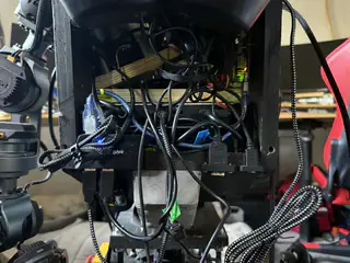 Rear interior view of the robot’s densely packed wiring, braided cable sleeves, and electronic modules.