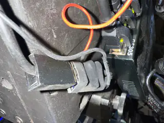 Small power switch and terminal block mounted beside red and black wires on the robot body.