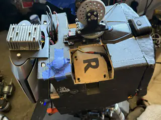 Top view of R.O.B.’s housing with shoulder joint, large gear, heat sink, and panel marked R.