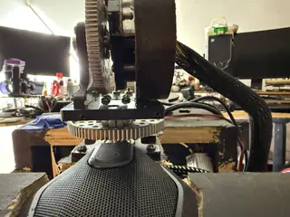 Centered view through the central mechanism showing large vertical and horizontal gears above the neck speaker.