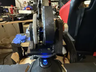 Front view of the upright neck gear assembly above a blue illuminated power button.
