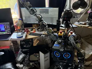 R.O.B. raises one long articulated arm high above its tracked base during a motion test.